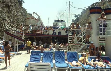 people enjoy sunning on ship's deck