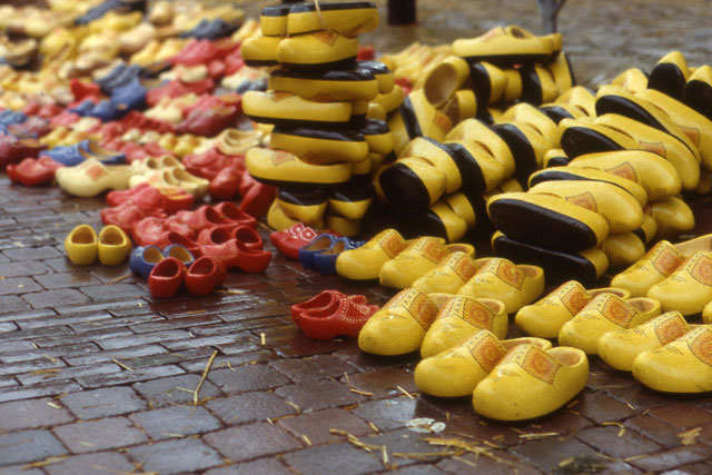 clogs stacked on street waiting to be sold