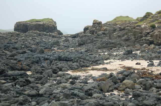 the volcanic-like rock of Coral Beach