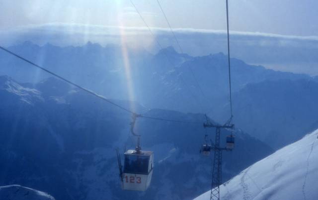 A cable car takes passengers over a portion of the Swiss Alps